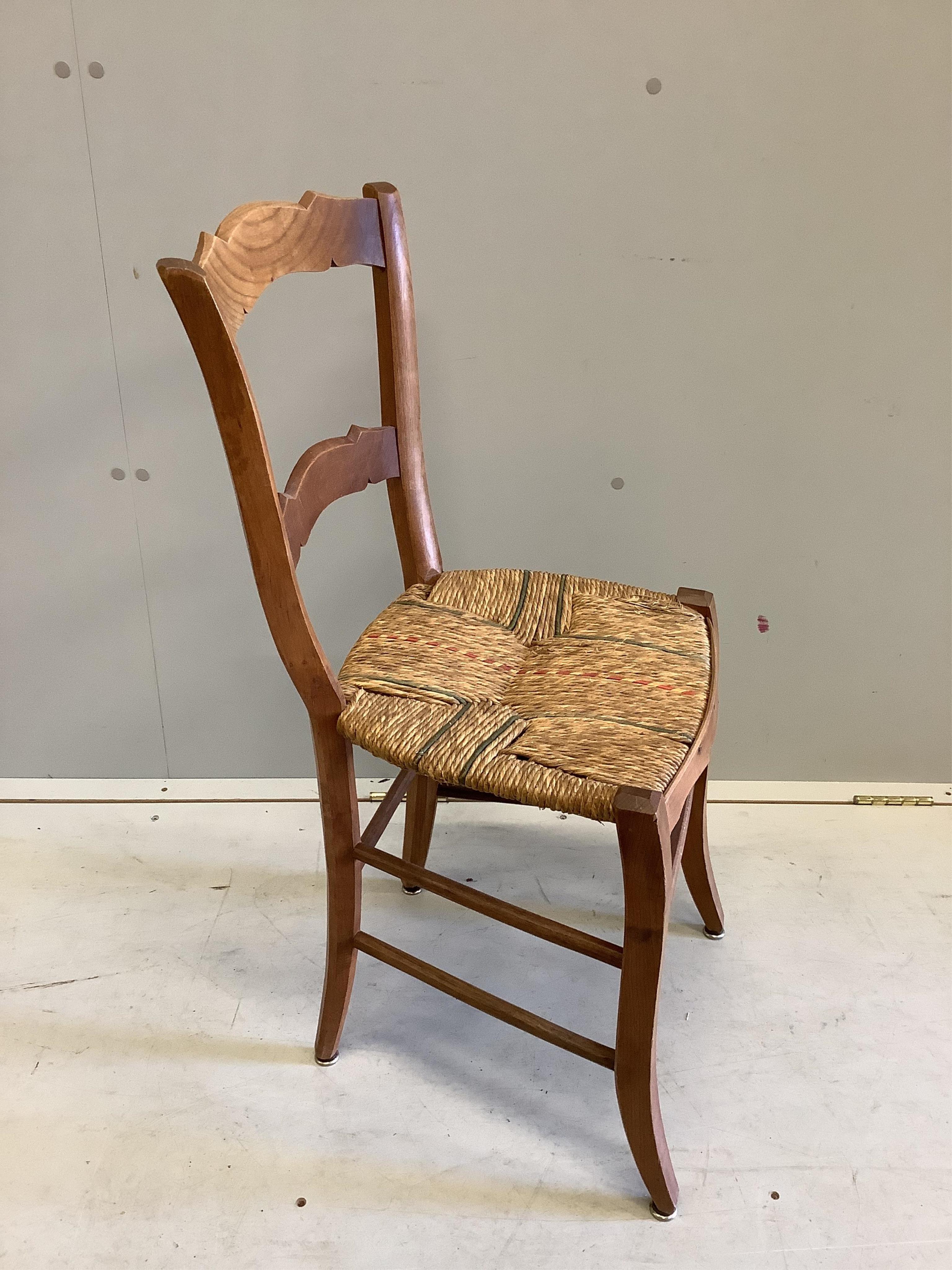 A set of six 19th century French fruitwood kitchen chairs, with rush seats, height 82cm. Condition - fair